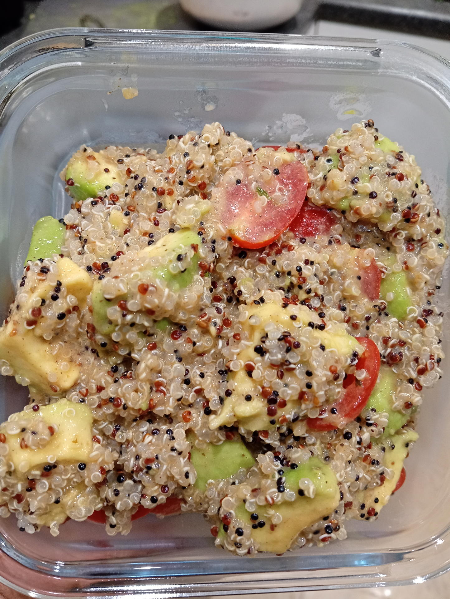 Quinoa and avocado salad with cherry tomatoes and quinoa seeds, mixed in a container in the Terroir kitchen