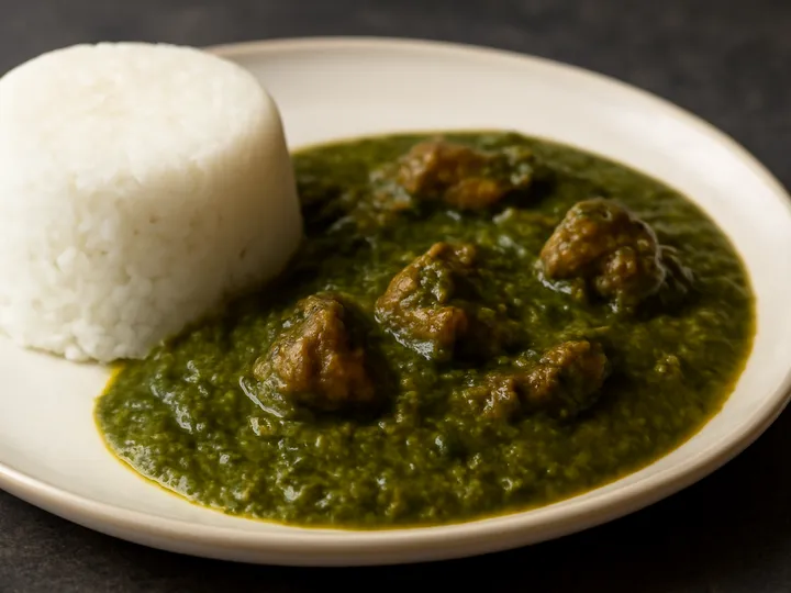 White Tuwo Shinkafa Mounds with Olive-Green Miyan Kuka — The finished dish
